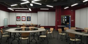 multiversity boardroom with black ceiling and white walls with hexagon shape tables and brown chairs