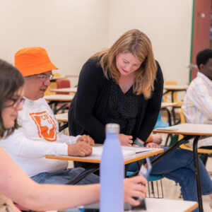 Professor helping student with doubt in class