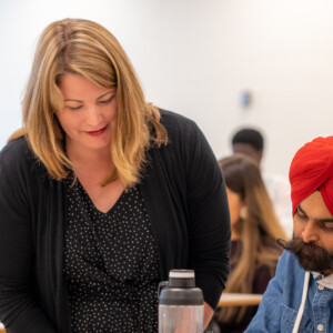 Professor helping student with doubt in class