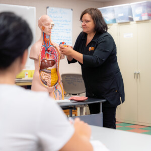 Professor teaching nursing students in lab