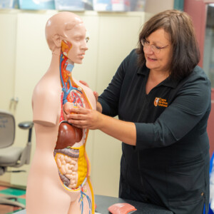 Professor teaching nursing students in lab