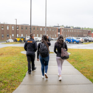 Two students walking on campus with CBU Campus security officer