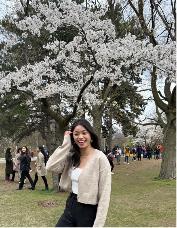 Alex Whyte in front of Cherry Blossom trees